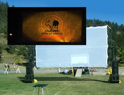Outdoor Projection screen showing daytime set-up and projection at night