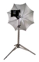 silver reflector umbrella shown with an omni light on a stand